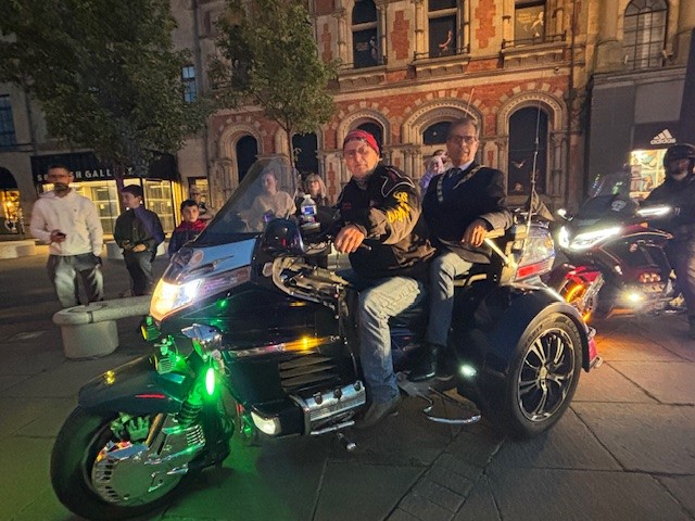 Mayor of Bishop Auckland, Councillor Sam Zair on the back of a Goldwing bike in the Market Place.