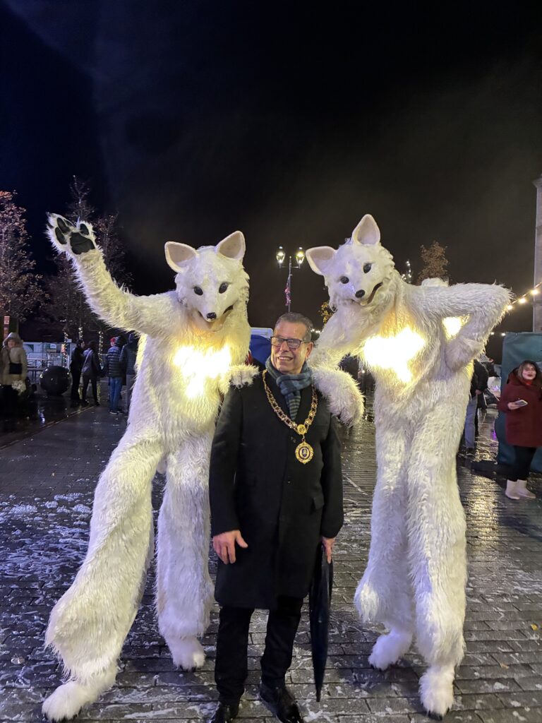 Mayor Sam Zair with Artic Fox Stilt Walkers at the Bishop Auckland's Christmas Town Parade (2025).