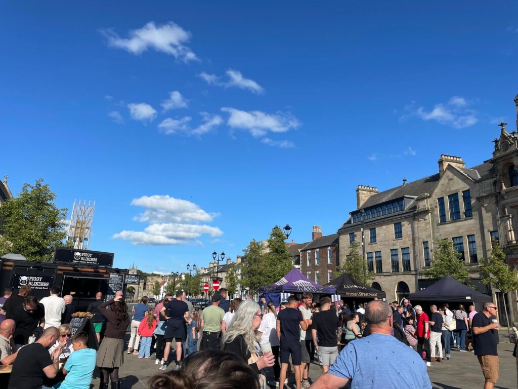 Crowds of people attending the Street food Market in Bishop Auckland Market Place.