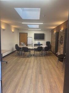 Conference Room on the ground floor. This room has a wall mounted screen.