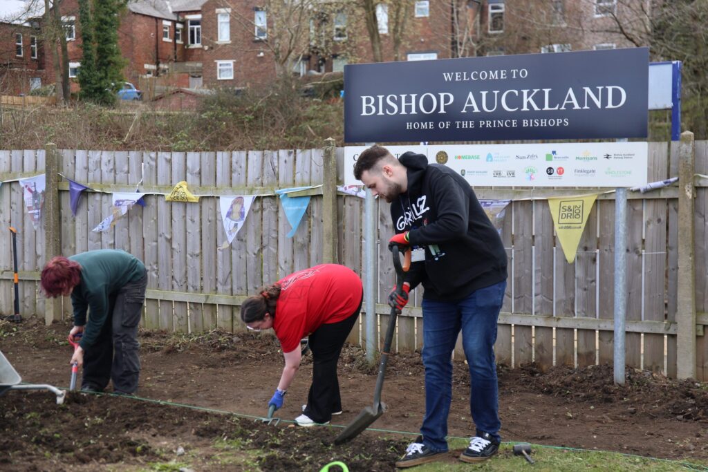 Students and staff from the College Week of Action at the Railway garden.