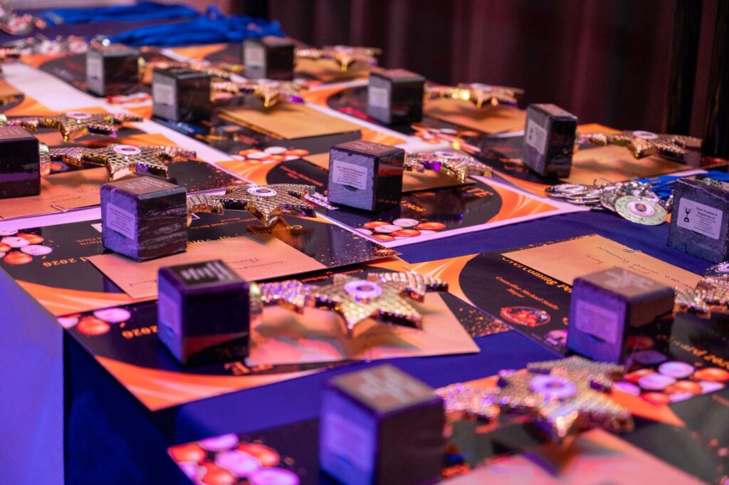 Trophies and Certificates Display on Stage at Youth Awards 2026.